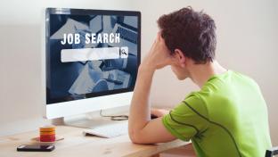 unemployment concept, job search on internet, man at home looking for good career; Shutterstock ID 702065437