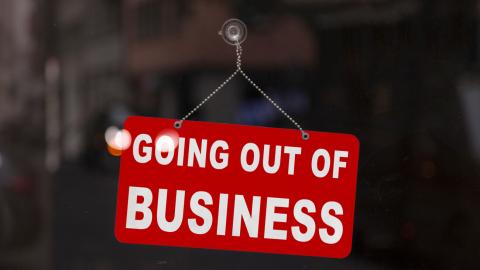 Close-up on a red closed sign in the window of a shop displaying the message "Going out of business".; Shutterstock ID 1721205958