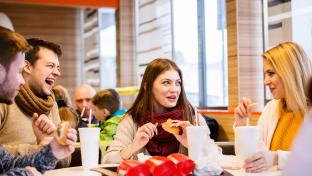 Group of young people eating out and talking, having fun in town; Shutterstock ID 476252911